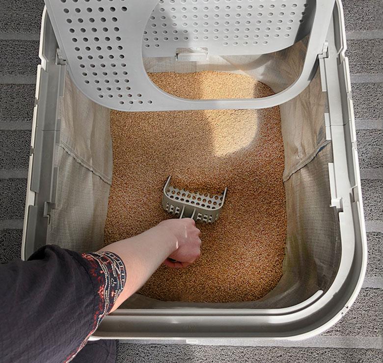 Owner cleaning a Modkat XL Litter Box